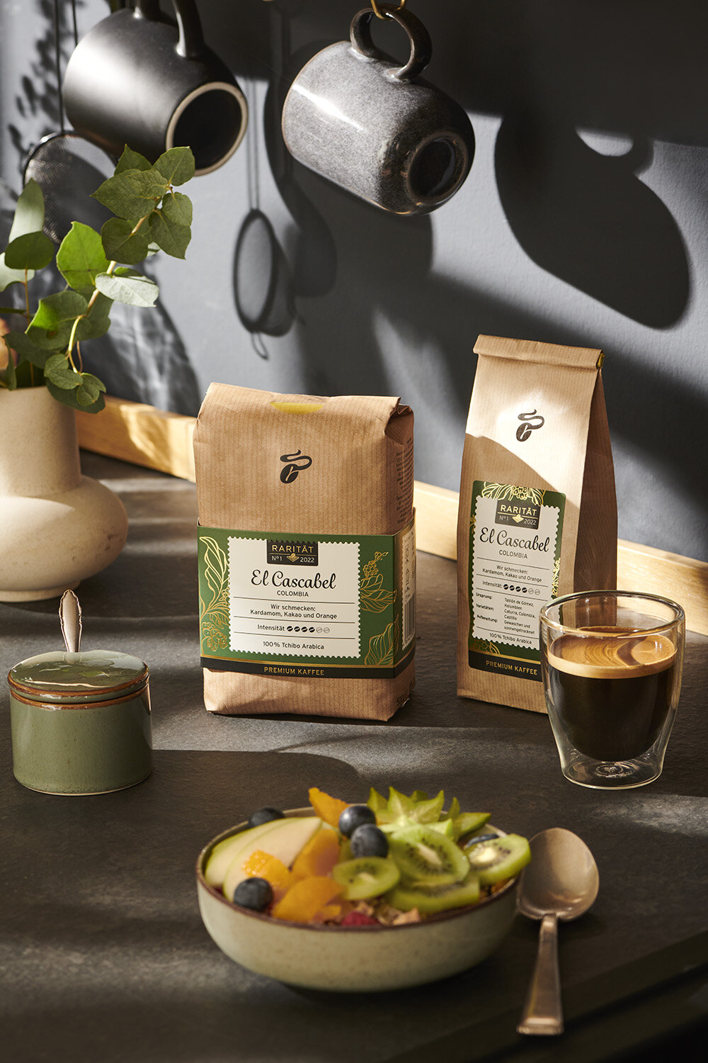 Kaffeepackungen mit Espresso und Obstschale