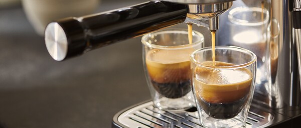 Espressomaschine brüht zwei Gläser Kaffee