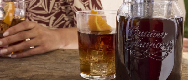 Mensch mit Drink und großes Glas mit dunklem Getränk