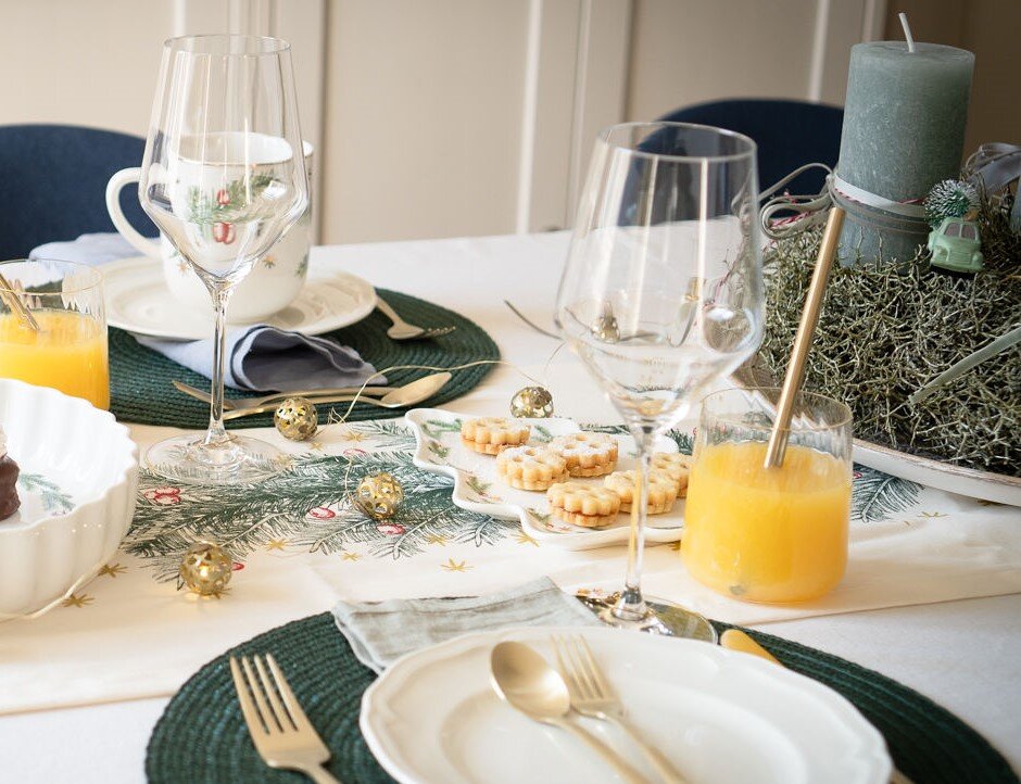 Weihnachtlich gedeckter Tisch mit Keksen und Saft