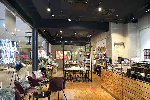 Ein gemütlicher Sitzbereich (links und in der Mitte des Stores) lädt zum Kaffeegenießen und Verweilen ein.