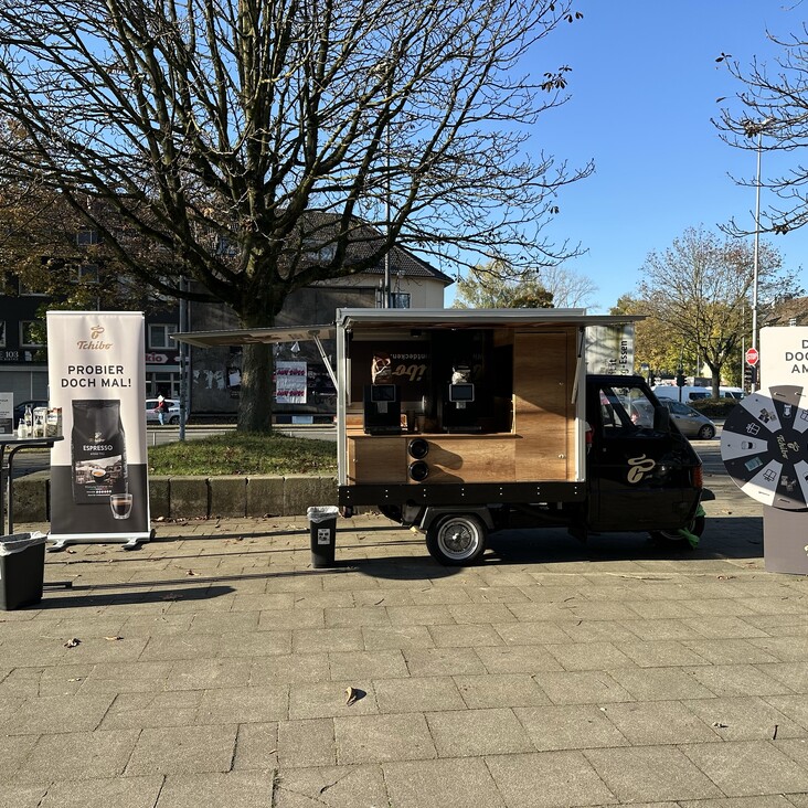 Tchibo-Kaffeewagen mit Werbebannern und Glücksrad