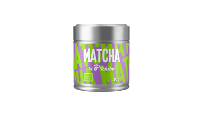 Silberne Matcha-Dose mit grün-lila Etikett