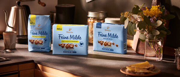 Drei Tchibo Feine Milde Kaffeepackungen auf Küchenarbeitsplatte