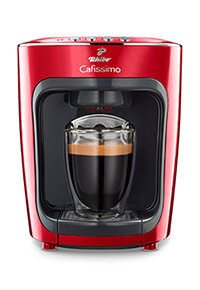 Rote Kapsel-Kaffeemaschine mit vollem Glas Espresso