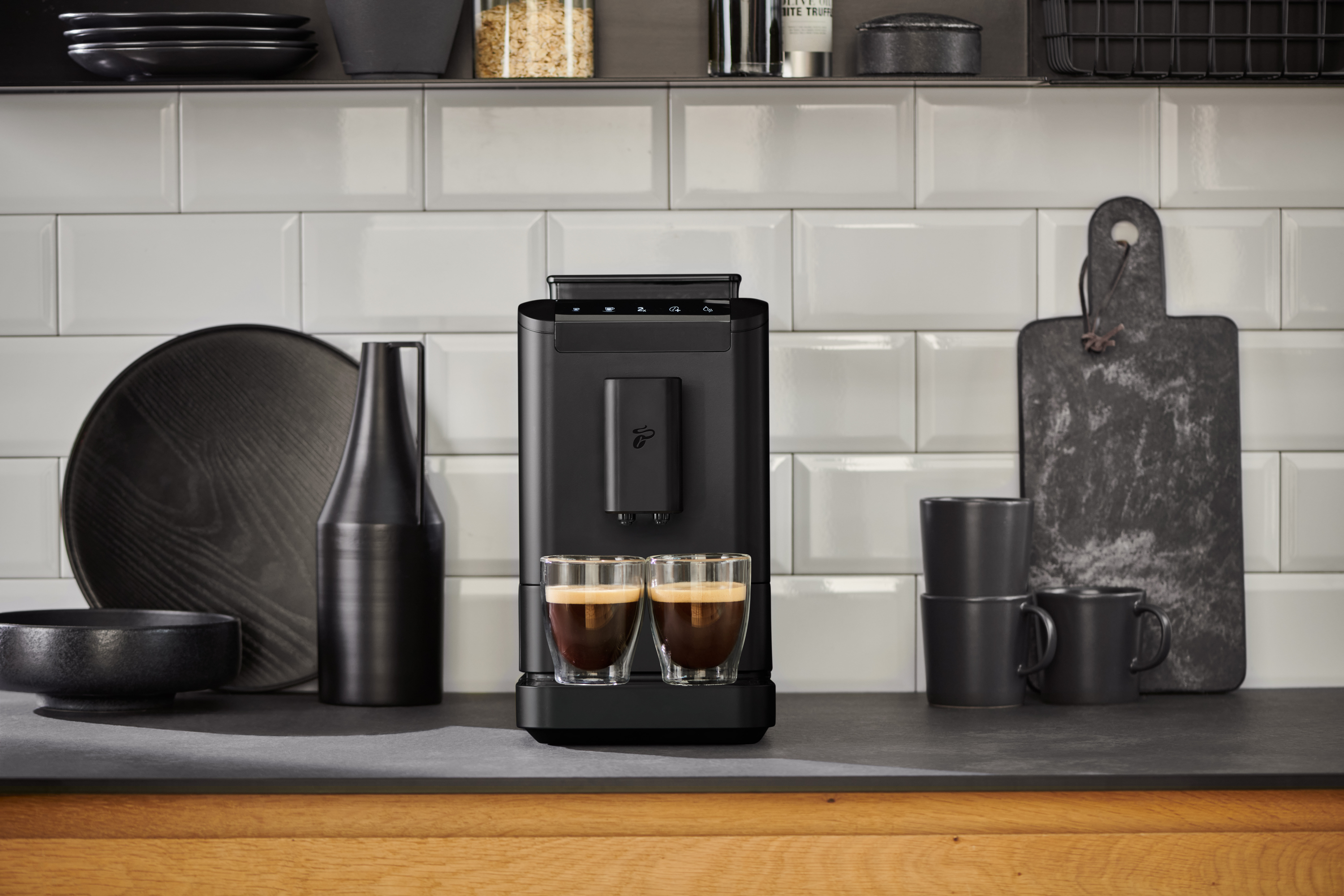 Schwarze Kaffeemaschine mit zwei Espressotassen