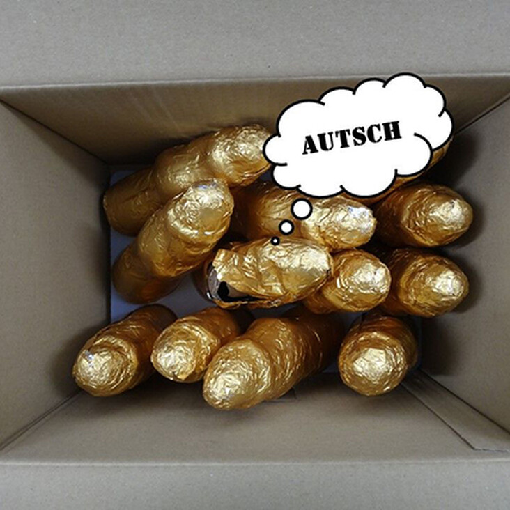 Goldene Folienobjekte in Karton, Sprechblase „AUTSCH“