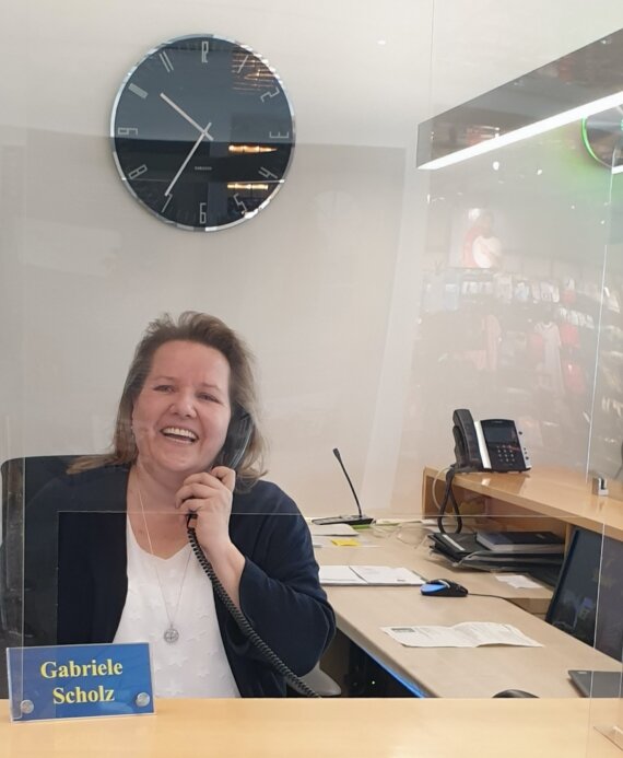 Frau am Empfangsschalter telefoniert