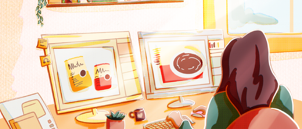 Grafikdesignerin arbeitet an zwei Monitoren
