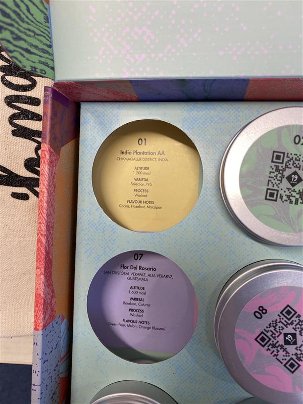 Bunte Kaffeebox mit beschrifteten Probendosen
