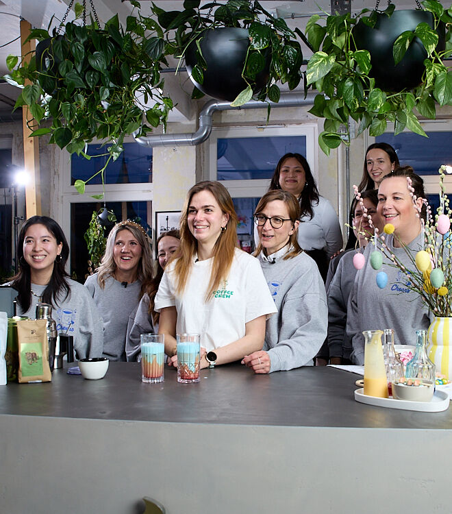 Group of people at a café counter with drinks