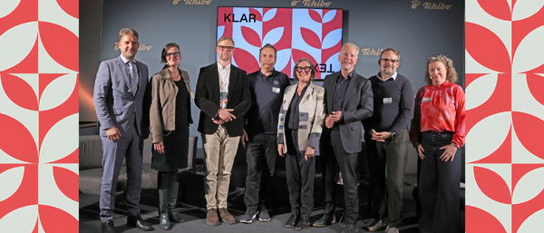 Group of nine professionals posing on stage