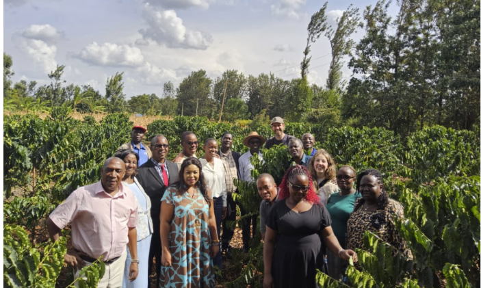 Group of people standing in a lush green farm